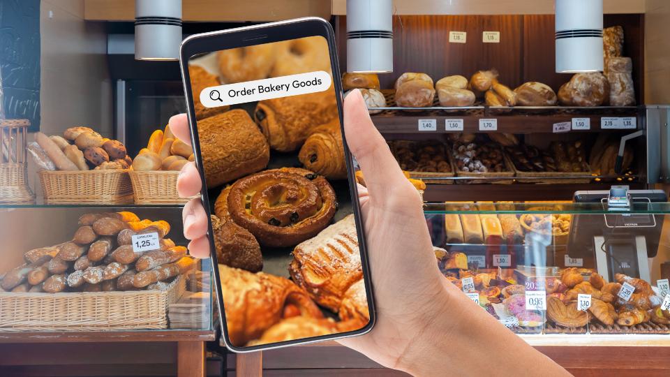 a person using a food waste app to order bakery goods