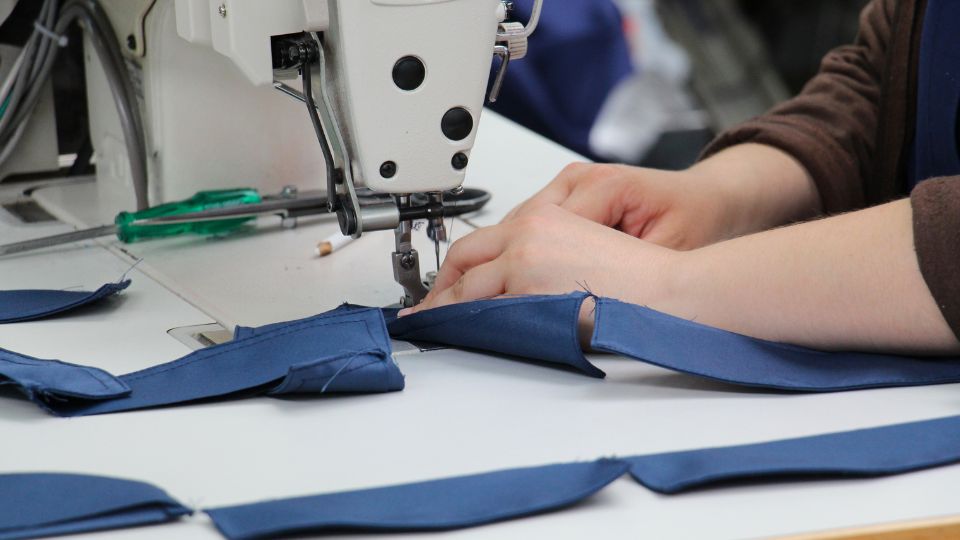 fast fashion production with someone working in a factory