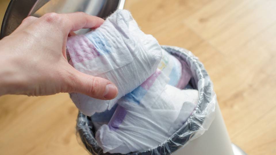 nappies going into a sanitary waste bin