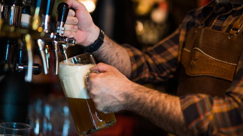 a bartender pouring a beer