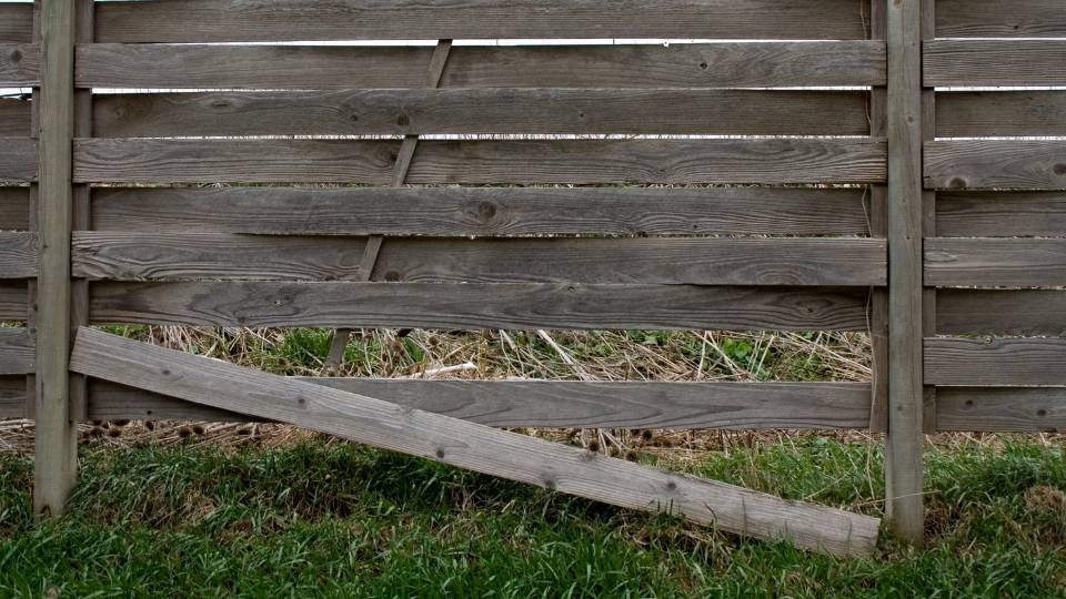 broken wooden fence that needs to be thrown away and disposed of 