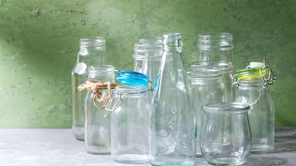 Glass jars and bottles on a table.