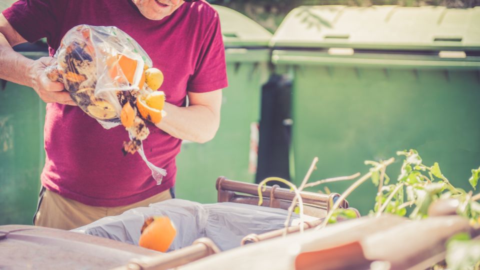 Person composting food waste from a food waste bag.