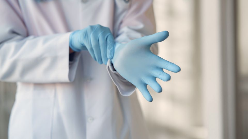 a doctor putting gloves on