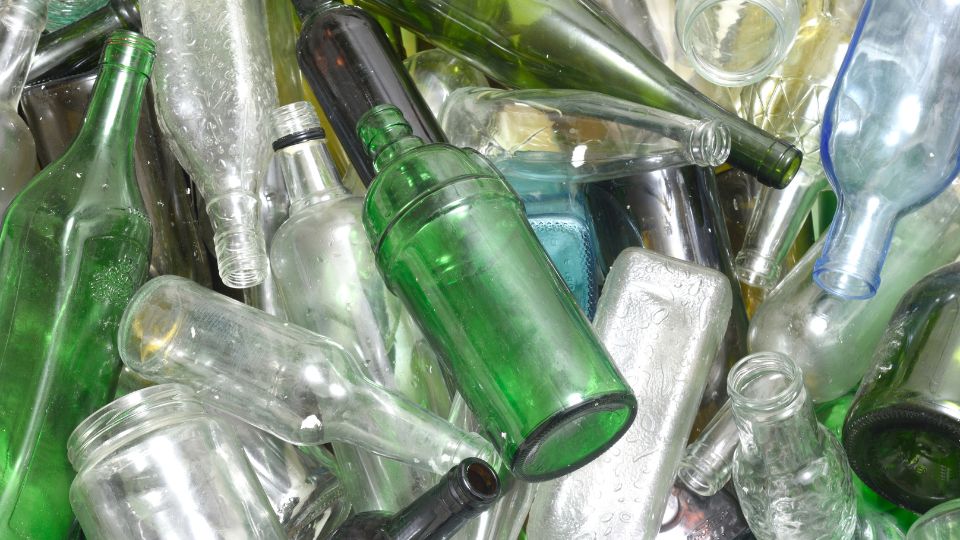 Glass bottle waste scattered.