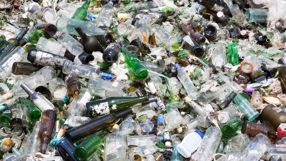 Glass waste and shards in landfill.