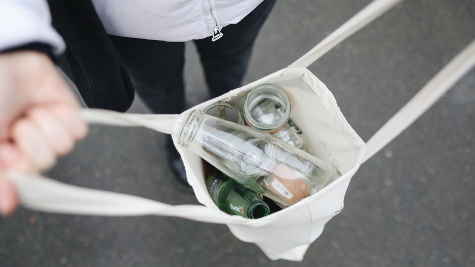 Bag filled with empty glass bottles.