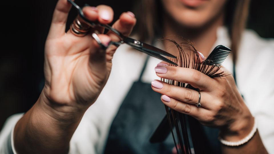 Hairdresser clipping hair.