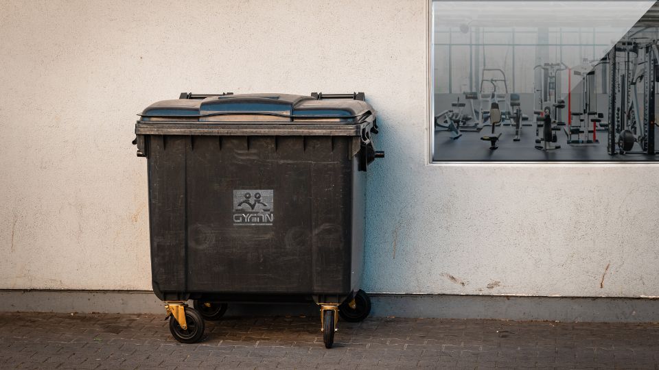 1100L wheelie bin outside a gym