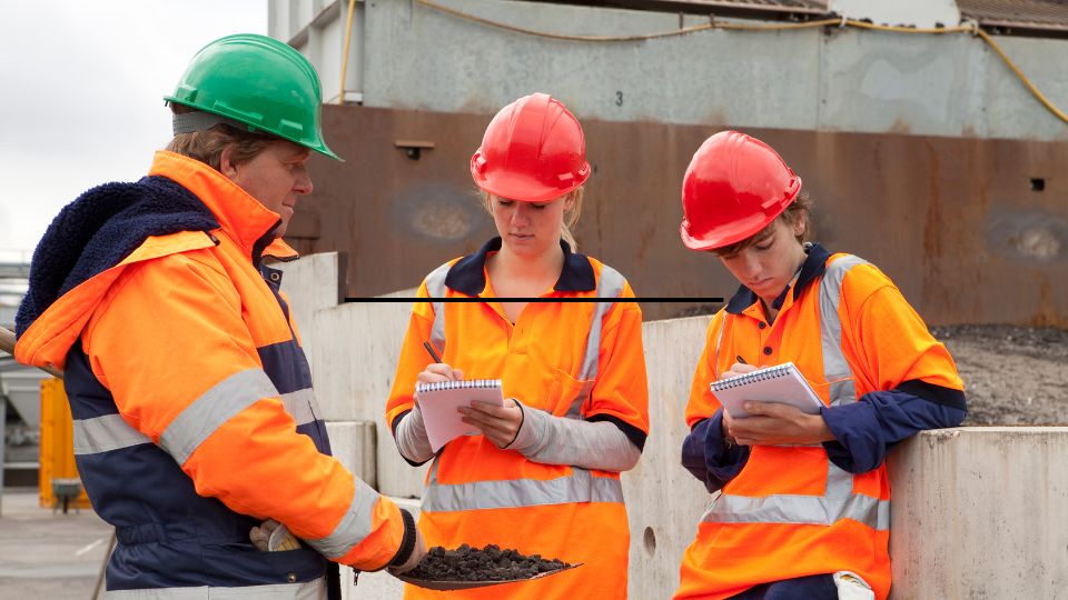 Employees being educated and taking notes.