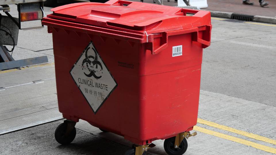 red clinical waste bin ready for collection