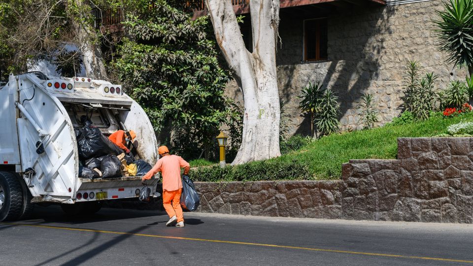 Waste being thrown in a bin lorry.