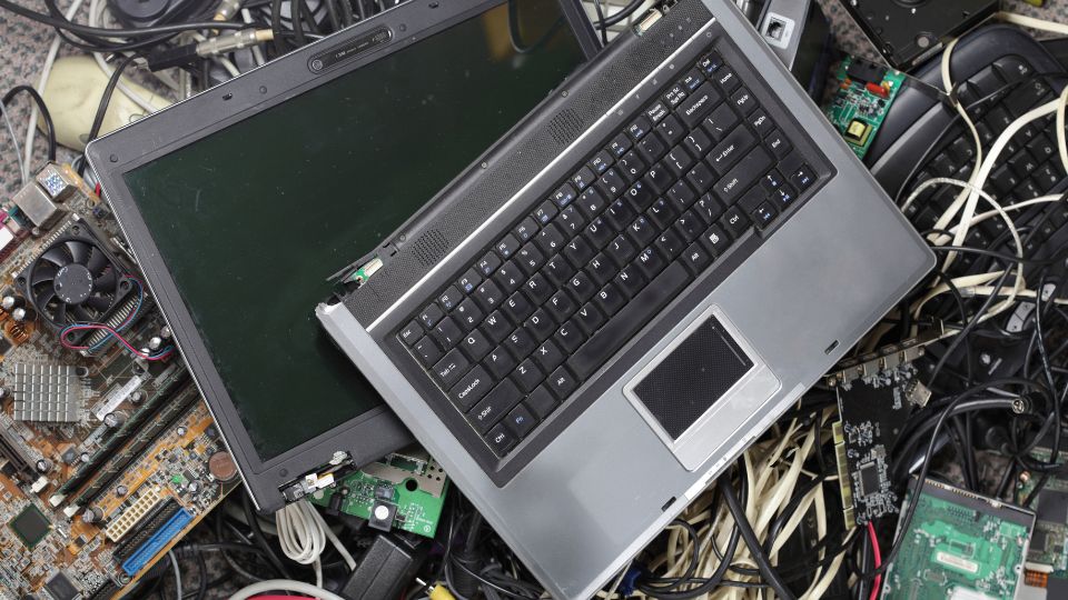 Old computer in e-waste pile.